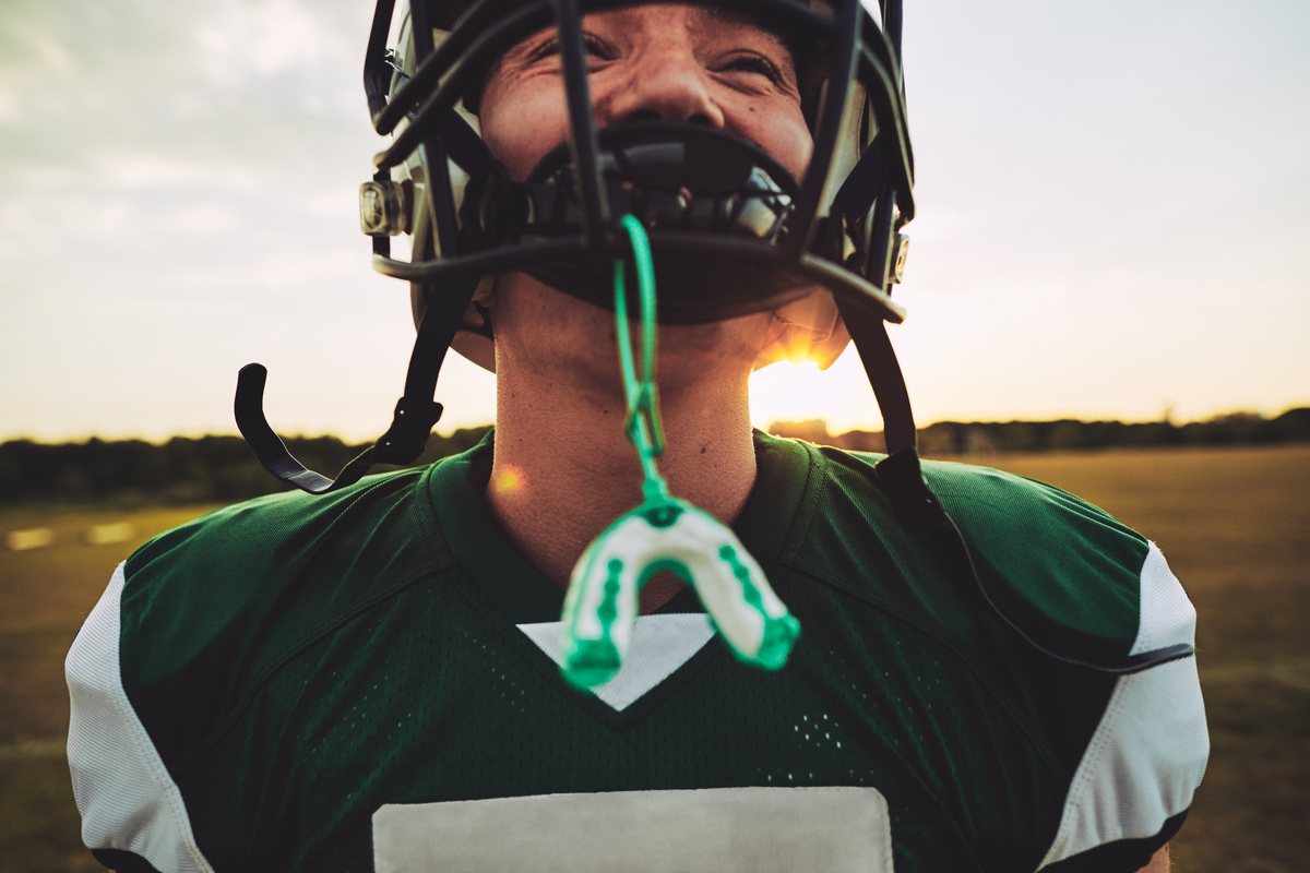 Young American football player standing on a field during practi